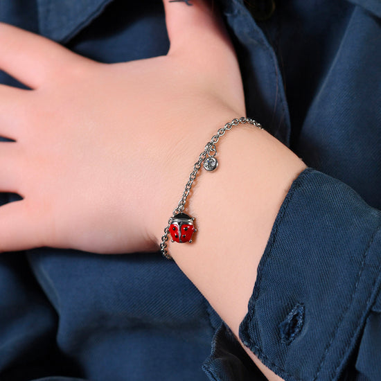 BRACCIALE BAMBINA IN ACCIAIO CON COCCINELLA CON SMALTO ROSSO E NERO E CRISTALLO