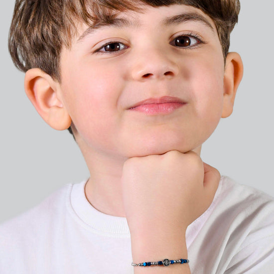 BRACCIALE BAMBINO IN ACCIAIO CON EMATITE BLU E TIMONE